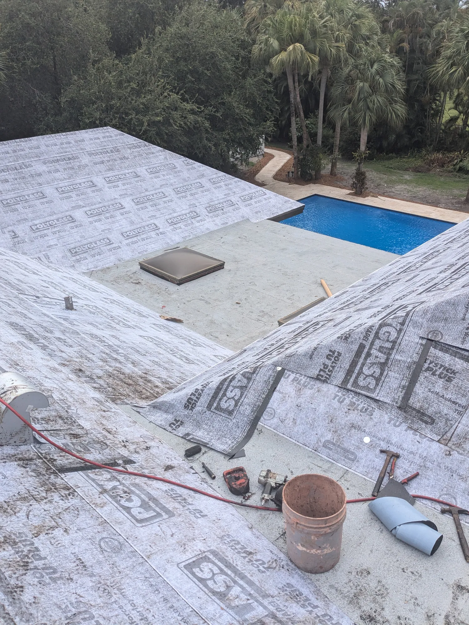 Charcoal flat tile roof installation by DR Construction & Roofing in South Florida