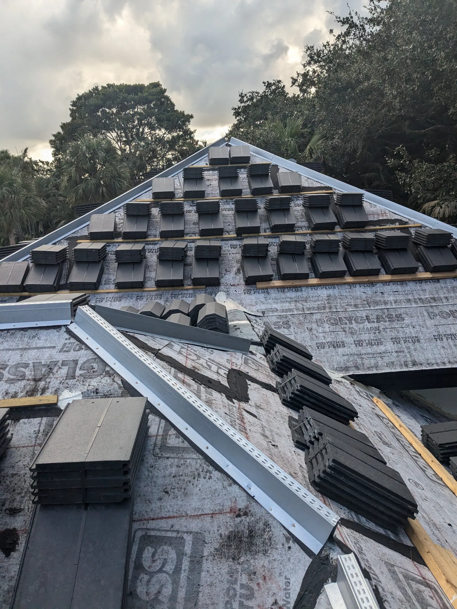 Charcoal flat tile roof installation by DR Construction & Roofing in South Florida