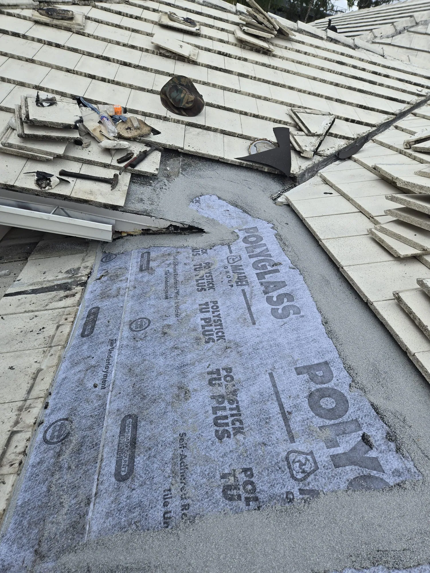 Polyglass underlayment product visible during a tile roof repair