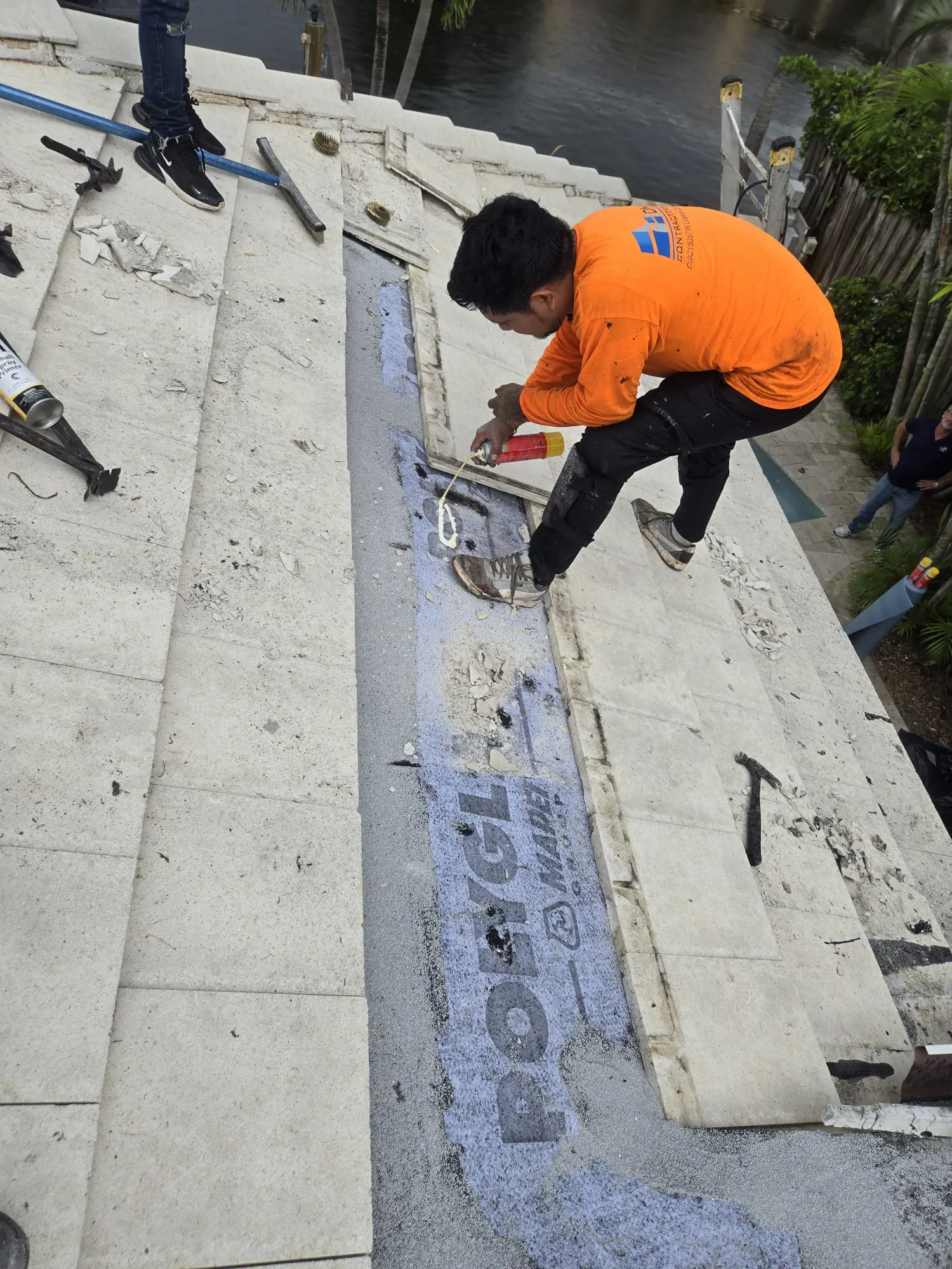 DR Construction worker mid-install during a tile roof repair in South Florida